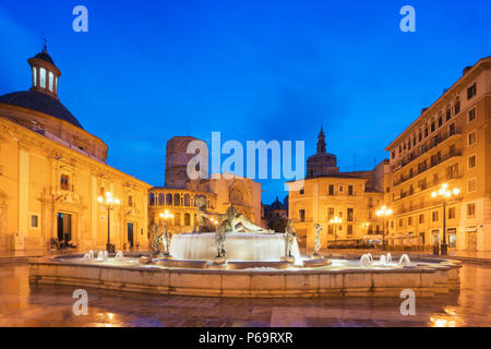 Fountain Rio Turia on Square of the Virgin Saint Mary, Valencia Cathedral, Basilica of Virgen the Helpless at night in Valencia, Spain. Stock Photo