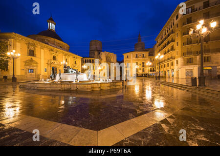 Fountain Rio Turia on Square of the Virgin Saint Mary, Valencia Cathedral, Basilica of Virgen the Helpless at night in Valencia, Spain. Stock Photo