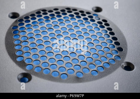 Close-up, shallow focus of a meshed style cooling panel used on a main frame computer. The circular holes aid active venting of hot air within the com Stock Photo