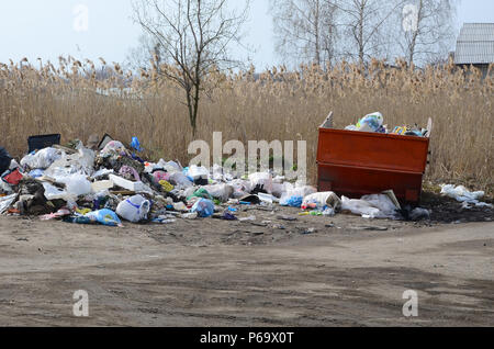 The garbage can is packed with garbage and waste. Untimely removal of garbage in populated areas . Stock Photo