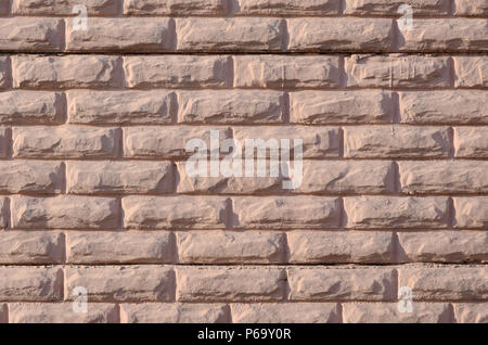 Texture of a relief concrete wall of beige color . Stock Photo