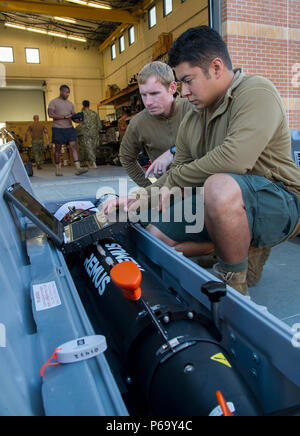 160514-N-SF508-007 PANAMA CITY, Fla. (May 14, 2016) — Engineman 1st Class Dustin Collins (left) and Boatswain’s Mate 1st Class Otelo Rodriguez (right), assigned to Mobile Diving and Salvage Unit 2 (MDSU) Unmanned Systems Platoon 204, conduct pre-mission checks on a Mk. 18. Mod. 1 unmanned underwater vehicle during an Expeditionary Mine Countermeasure (ExMCM) certification exercise at Naval Support Activity Panama City, Fla. (U.S. Navy photo by Mass Communication Specialist 2nd Class Charles Oki/Released) Stock Photo