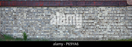 The texture of the warehouse wall from a variety of rough stones of different shades . Stock Photo