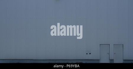 Texture of a high metal wall of an industrial building without windows . Stock Photo