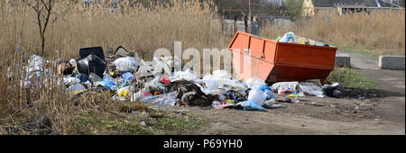 The garbage can is packed with garbage and waste. Untimely removal of garbage in populated areas . Stock Photo