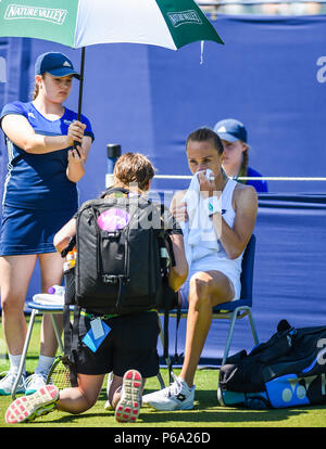 Magdalena Rybarikova of Slovakia with the physio on court before retiring hurt against Su-Wei Hsieh of Taiwan during the Nature Valley International tennis tournament at Devonshire Park in Eastbourne East Sussex UK. 26 June 2018 Stock Photo