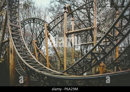 Abandoned theme park roller coaster ride in autumn in europe Stock Photo