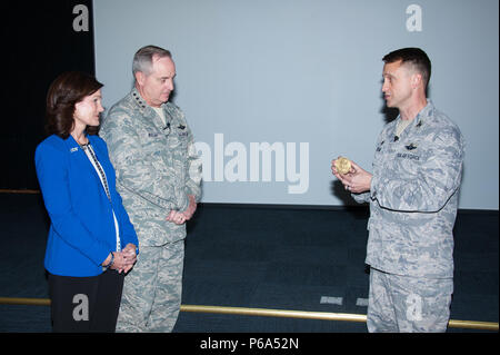 Maxwell AFB, Ala. - General Mark A. Welsh, III, twentieth Chief of Staff of the US Air Force and his wife  are presented medallions honoring their outstanding contributions to the educational success of the Ira C. Eaker Center for Professional Development and its Wing Commander and Wing Commander Spouses courses by ECPD Commander Colonel Kenneth Tatum in the Kaysing Auditorium, April 14, 2016.  (US Air Force photo by Melanie Rodgers Cox/Released) Stock Photo