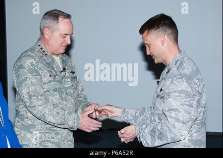 Maxwell AFB, Ala. - General Mark A. Welsh, III, twentieth Chief of Staff of the US Air Force is presented a medallion honoring his and his spouse's outstanding contributions to the educational success of the Ira C. Eaker Center for Professional Development and its Wing Commander and Wing Commander Spouses courses by ECPD Commander Colonel Kenneth Tatum in the Kaysing Auditorium, April 14, 2016.  (US Air Force photo by Melanie Rodgers Cox/Released) Stock Photo