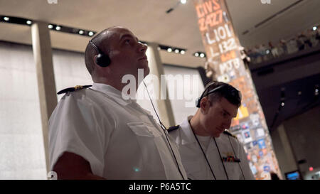 160527-N-OE749-016 NEW YORK CITY (May 27, 2016) From left, Lt. Cmdr. Charles Farlow and Lt. Jeff Graverholt, both assigned to Carrier Strike Group 12, view exhibits inside of the 9/11 Memorial Museum, May 27. The museum was open free of charge to active duty military and veterans as part of 2016 Fleet Week New York (FWNY). FWNY, now in its 28th year, is the city's time-honored celebration of the sea services. It is an unparalleled opportunity for the citizens of New York and the surrounding tri-state area to meet Sailors, Marines and Coast Guardsmen, as well as witness firsthand the latest cap Stock Photo