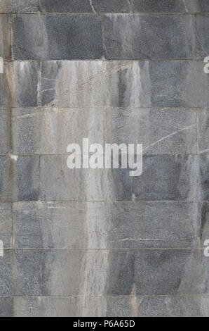 Background texture of a wall from an old gray granite tiles . Stock Photo