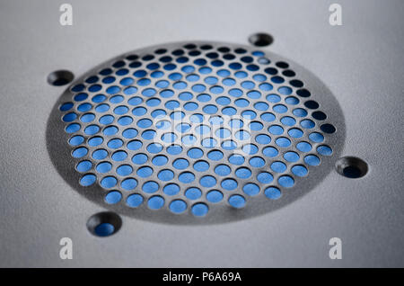 Close-up, shallow focus of a meshed style cooling panel used on a main frame computer. The circular holes aid active venting of hot air within the com Stock Photo