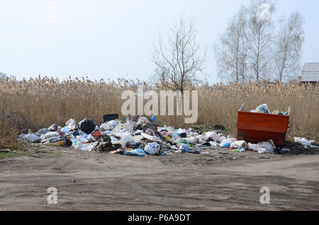 The garbage can is packed with garbage and waste. Untimely removal of garbage in populated areas . Stock Photo