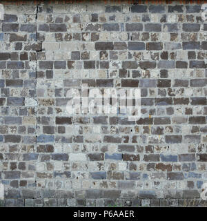 The texture of the warehouse wall from a variety of rough stones of different shades . Stock Photo