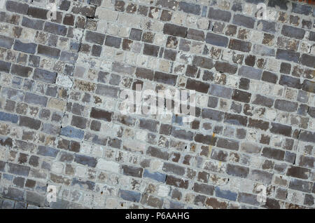 The texture of the warehouse wall from a variety of rough stones of different shades . Stock Photo