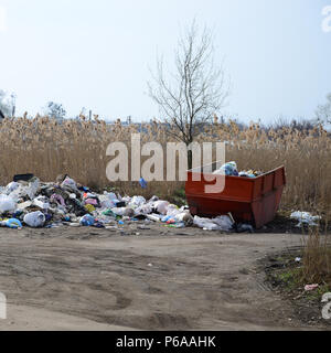 The garbage can is packed with garbage and waste. Untimely removal of garbage in populated areas . Stock Photo