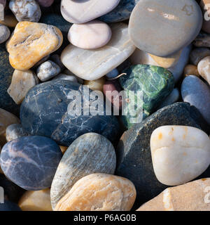 A group of various colorful small stones direct sunlight Stock Photo