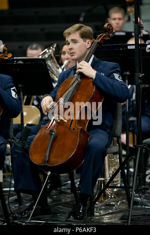 U.S. Air Force Tech. Sgt. Edward Prevost, U.S. Air Force Concert Band cellist, plays the cello during a Concert Band and Singing Sergeants performance at Little Rock Central High School, in Little Rock, Ark., Apr. 7, 2016. The Concert Band and Singing Sergeants are performing across five states during a 12-day spring tour. (U.S. Air Force photo by Capt. Casey Staheli/Released) Stock Photo