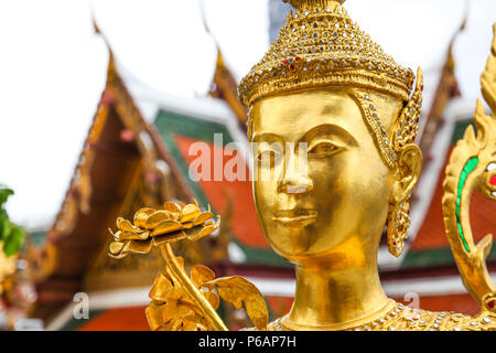 Golden Kinnari statue  at Wat Phra Kaew ,The Temple of Emerald Buddha in Bangkok, Thailand Stock Photo