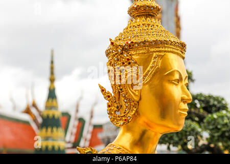 Golden Kinnari statue  at Wat Phra Kaew ,The Temple of Emerald Buddha in Bangkok, Thailand Stock Photo