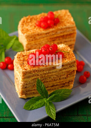 Sponge cake portions with red currants. Stock Photo