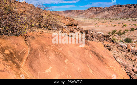 Twyfelfontein (uncertain spring, jumping waterhole),a site of ancient rock engravings in the Kunene Region of north-western Namibia. It consists of a  Stock Photo