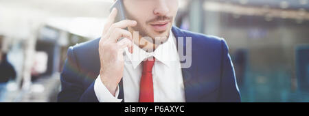 Young trendy businessman calling in business center closeup Stock Photo