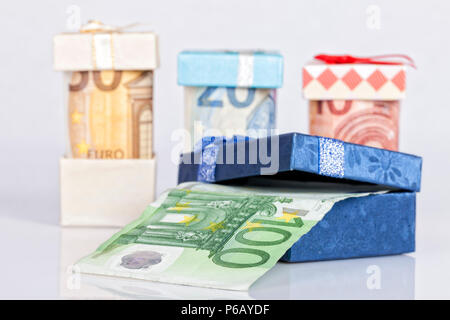 Several euro bills inside gift boxes isolated on white background. Stock Photo
