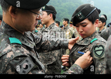 1st Lt. Jung, Ji Eun an infantryman and a Seoul native , 2nd Company, 115th Mechanized Infantry Battalion, 90th Mech. Inf. Brigade, 30th Mech. Inf. Division is pinned as the first female of Korea army officer to earn the U.S. Expert Infantry Badge, on Camp Casey, South Korea, May 26. Jung as receive a Certificate of Achievement. (U.S. Army photos by Mr. Pak, Chin-U, 2nd Infantry Division/ROK-U.S. Combined Division Public Affairs Office) Stock Photo