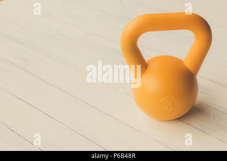 Yellow circle dumbbell on white wooden tabletop use for your health care Stock Photo