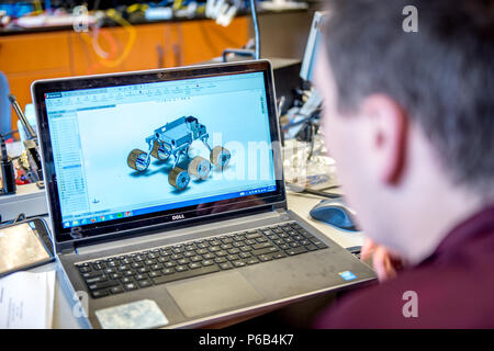 A Mechanical Engineering student on the Cornell University Mars Rover Team works on a computer-generated rover model for entry in the University Mars Rover Challenge at Phillips Hall, Ithaca, New York, on April 16, 2016. The project integrates robotics, mechanical design, programming, and simulation to test rover functionality. Faculty and team members evaluate performance, design accuracy, and operational reliability while applying STEM principles to aerospace exploration and research. Stock Photo