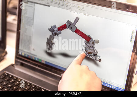 A mechanical engineering student from Cornell University works on a computer-generated design of a mechanical arm for a rover to be entered in the University Mars Rover Challenge. Activities took place in Phillips Hall laboratory, emphasizing engineering design, STEM education, robotics development, aerospace research, teamwork, technical analysis, model testing, project planning, prototyping, and innovation in preparation for a competitive intercollegiate rover challenge. Stock Photo