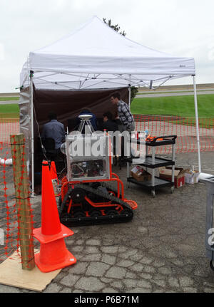 AFRL Student Challenge is an annual program sponsored by the Air Force Research Laboratory to provide college seniors with applied engineering experience aligned with United States Air Force requirements. The archival image documents students preparing a robotic sentry system for obstacle course demonstration during the 2017 challenge event organized with support from the Ohio Aerospace Institute. Stock Photo