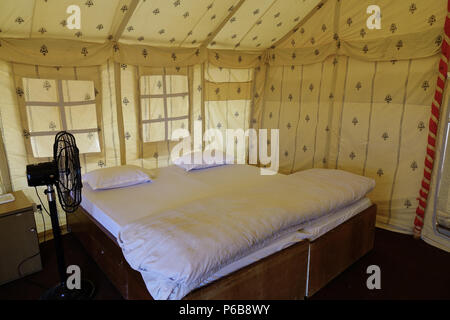 Jaisalmer, India - Nov 8, 2017. Interior of a luxury camping tent with king size bed on Thar Desert in Jaisalmer, India. Stock Photo