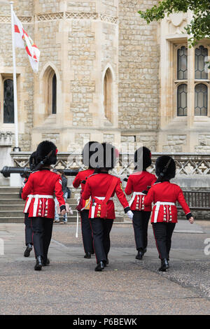 London, UK - 7th June 2017: The Queens Guard on parade at the Tower of London, in traditional red and black uniform with bearskin hats. Stock Photo