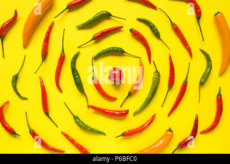 Assorted chili pepper tomato cherry On yellow bright background. Stock Photo
