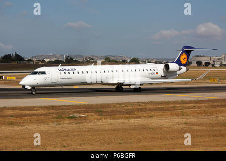 Bombardier CRJ900 small short haul jet airliner operated by Lufthansa CityLine taxiing for departure on a flight from Malta. Air travel in Europe. Stock Photo