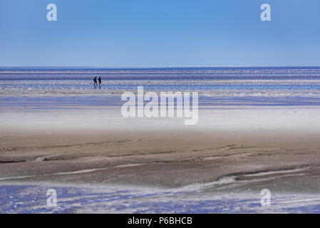 Walkers on Morecambe Bay sands. Lancashire North West England. Stock Photo