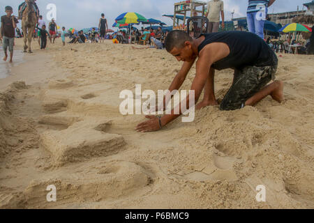 The seashore of the Gaza Sea is crowded with holidaymakers and is the only place where Gazans feel free. Stock Photo