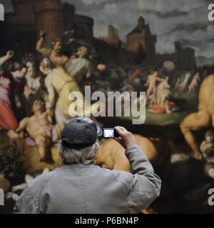 Man photographing a painting. Stock Photo