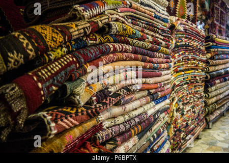 A Pile of Carpets in turkish Carpet Shop In Cappadocia Stock Photo