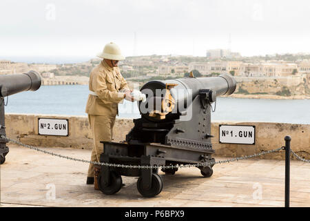 Number 1 Gun of the Saluting Battery artillery battery being prepared / loading powder charge / being loaded to fire the 4pm time signal. Valletta. Malta Stock Photo
