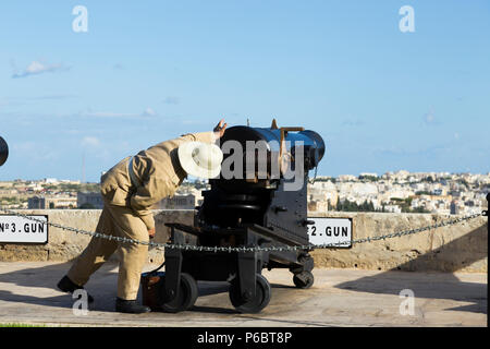 Number 2 Gun of the Saluting Battery artillery battery being prepared / loading powder charge / being loaded to fire the 4pm time signal. Valletta, Malta. Stock Photo
