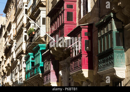 Maltese gallarija  / balconies; typical Maltese enclosed painted wooden balcony with glass windows on apartment buildings in Valletta, Malta. (91) Stock Photo