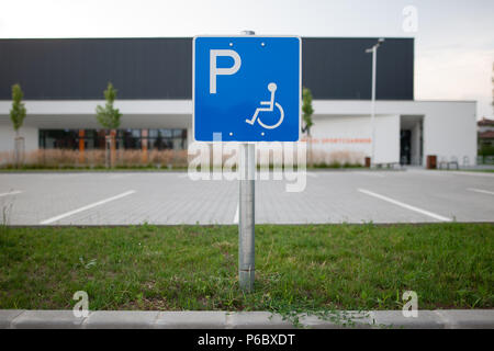 Disabled traffic sign at an empty car park represent handicap parking space without car or people