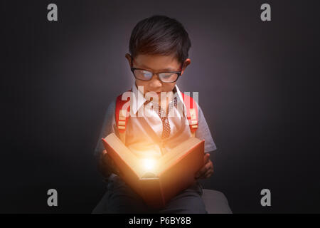Back to school, Child opened a magic book, Image dark tone Stock Photo