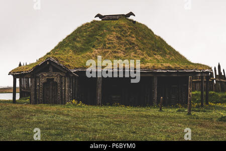 old viking village in iceland with foggy hill. old wooden buildings covered grass Stock Photo