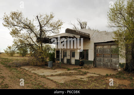 An abandoned gas station and garage along old Route 66 in the town of Adrian, Texas, the midpoint of the legendary cross-country road. Stock Photo
