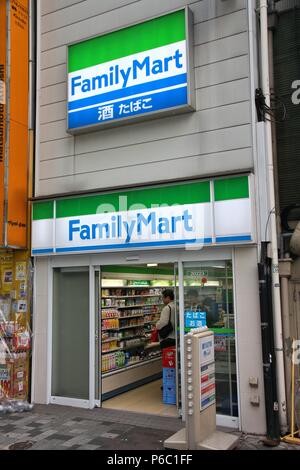 TOKYO, JAPAN - MAY 9, 2012: People visit Family Mart convenience store in Tokyo. FamilyMart is one of largest convenience store franchise chains in Ja Stock Photo