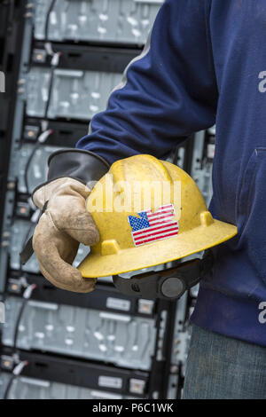 Engineer carrying hard hat with rubber protective gloves Stock Photo